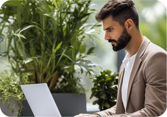 Man working on a laptop in a bright, modern office space