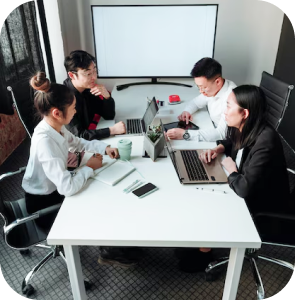 Conference room with a large screen and chairs around a table